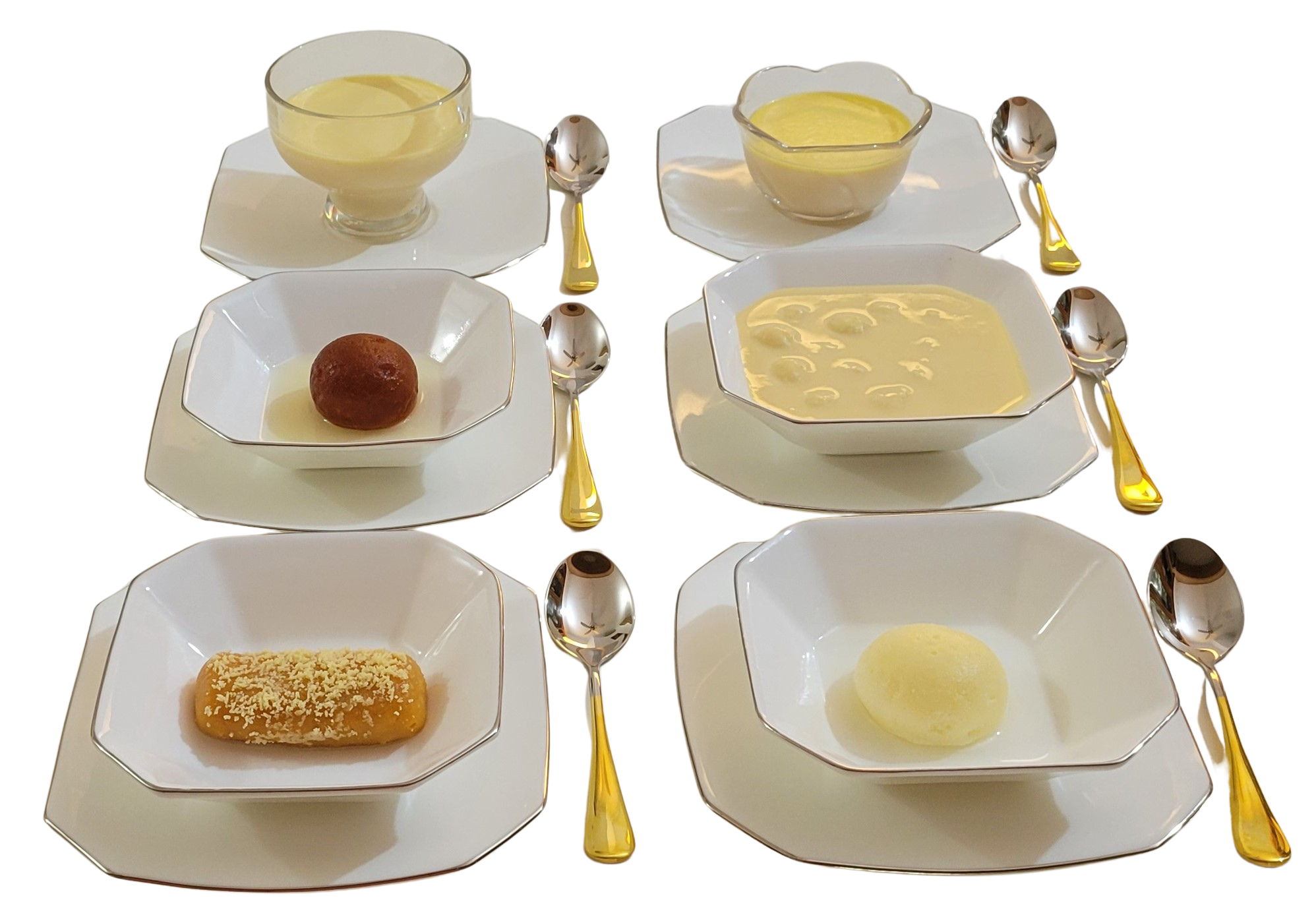 Plated Artees desserts on white porcelain with gold spoons